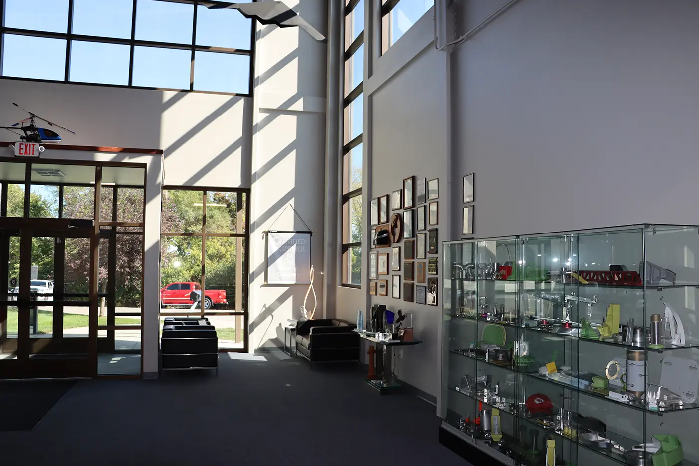 A room with lots of glass shelves and windows.