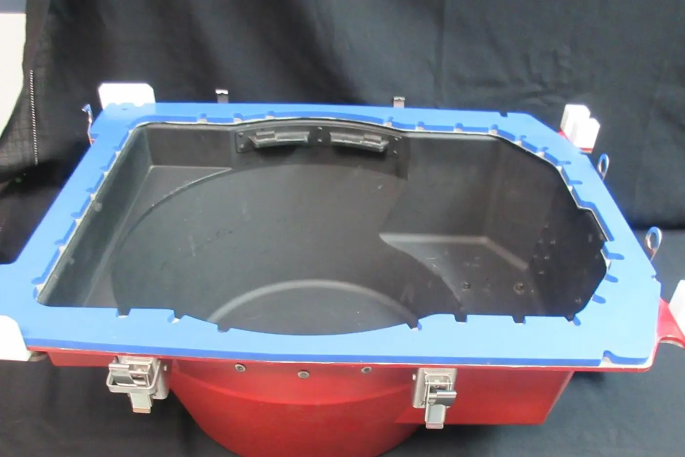 A red and blue container with a lid.