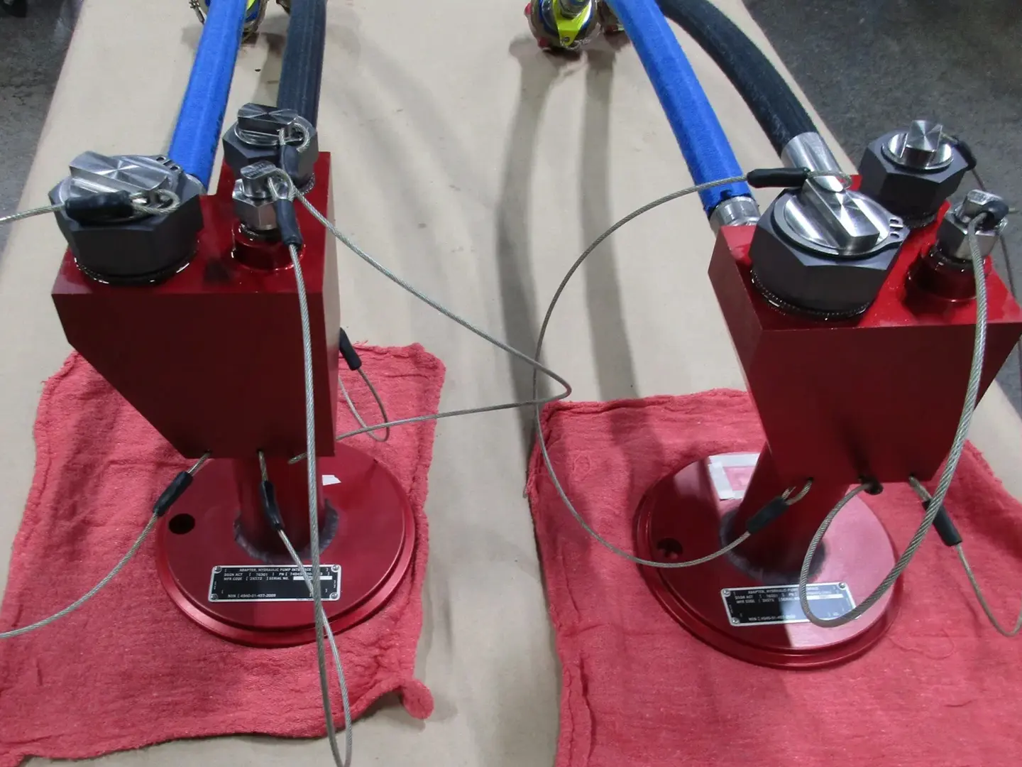 Two red stands with a blue hose connected to them.