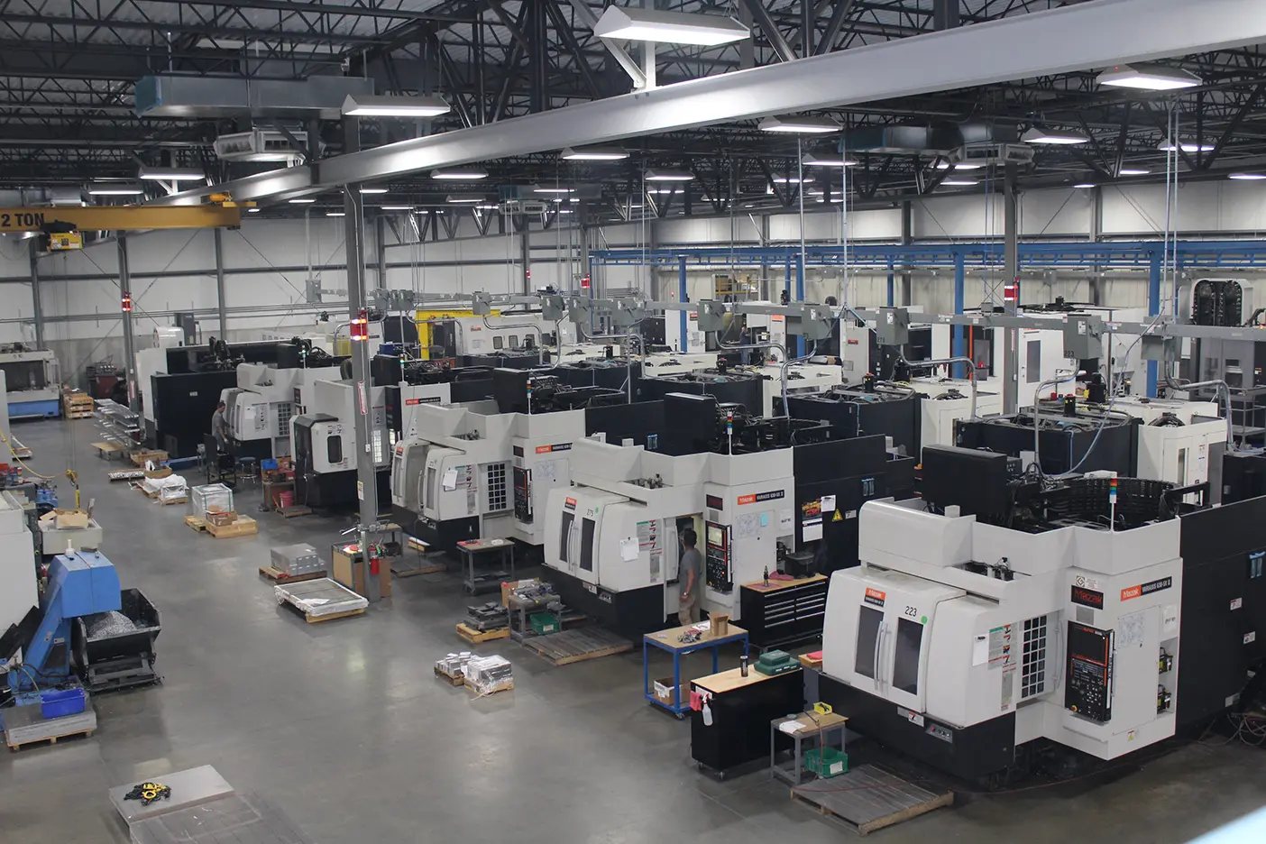 A large warehouse filled with machines and boxes.