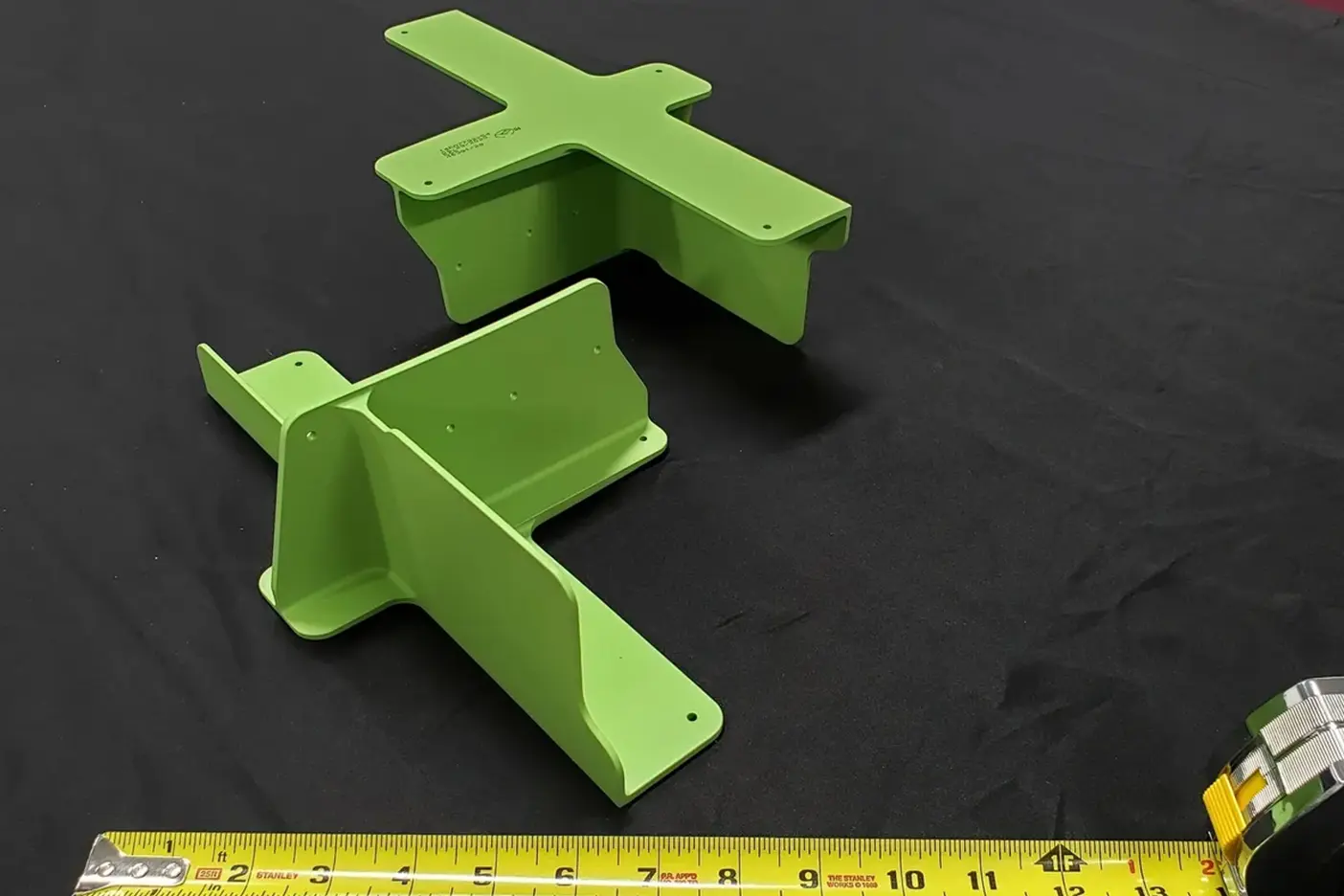 A pair of green plastic pieces sitting on top of a table.