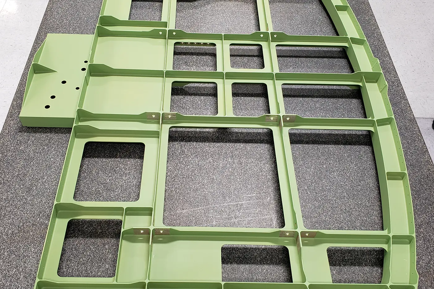 A green metal frame with multiple squares on it.