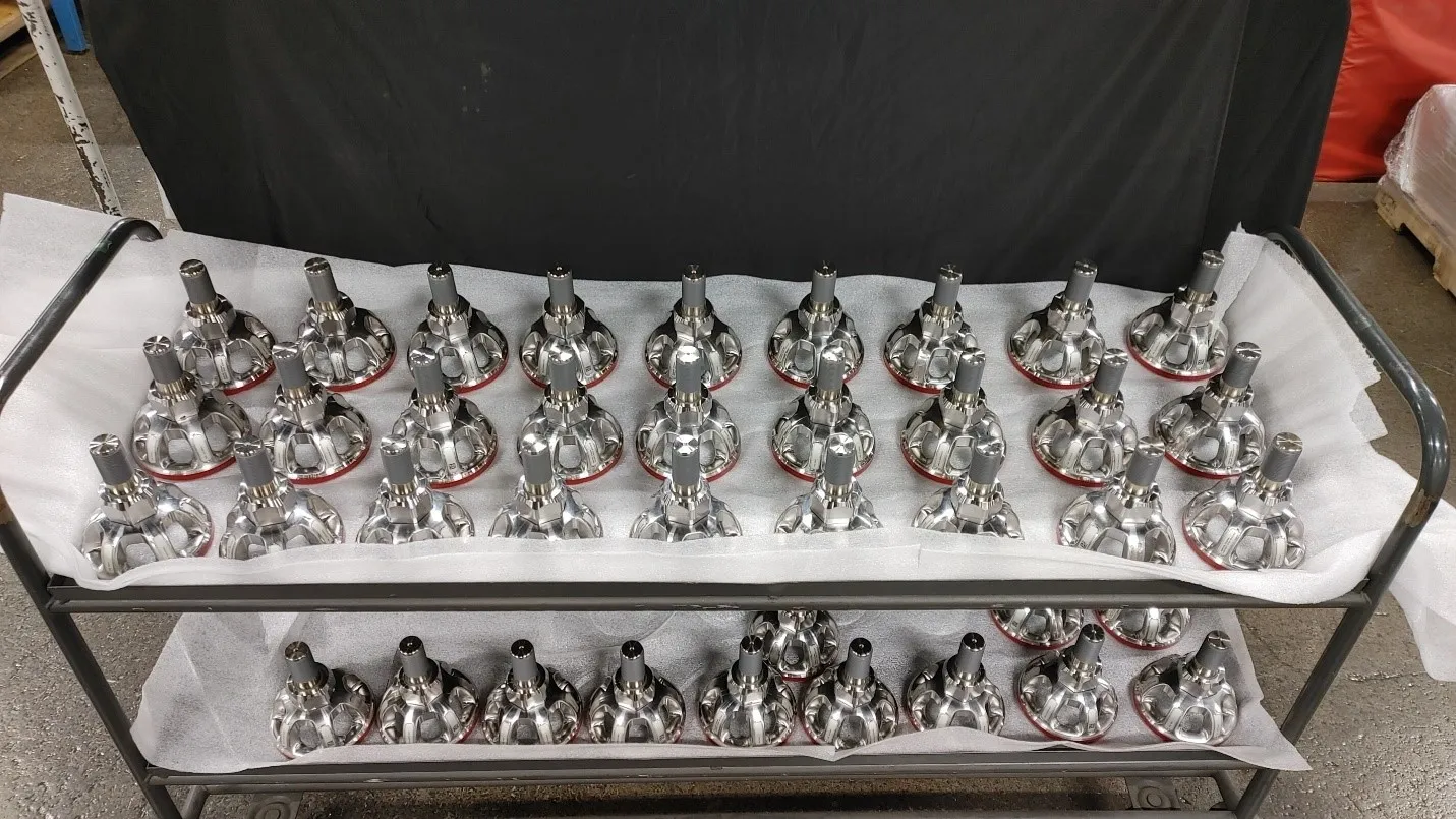 A large amount of silver statues sitting on top of each other.