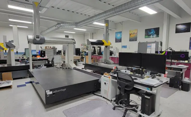 A large machine room with many computers and monitors.